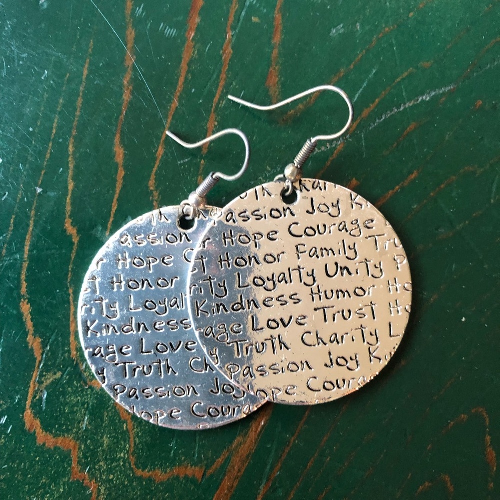 Silver earrings with wording on them